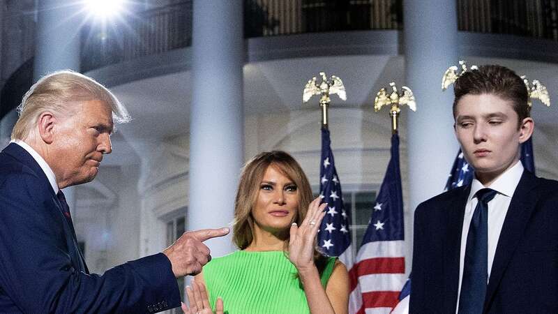 Barron has appeared in the public eye more and more recently - in 2020 then-President Trump (L) gestured toward his first lady Melania Trump and his youngest son after delivering his acceptance speech for the Republican presidential nomination (Image: Getty Images)