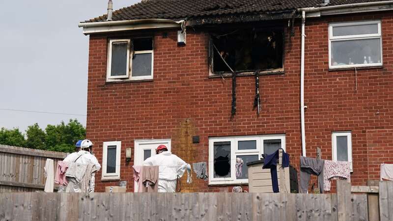 Forensic officers at the scene in Wolverhampton after two women died and four people were injured in a house fire (Image: PA)