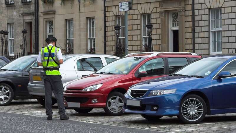 A parking attendant issuing a ticket (Image: Getty Images/iStockphoto)