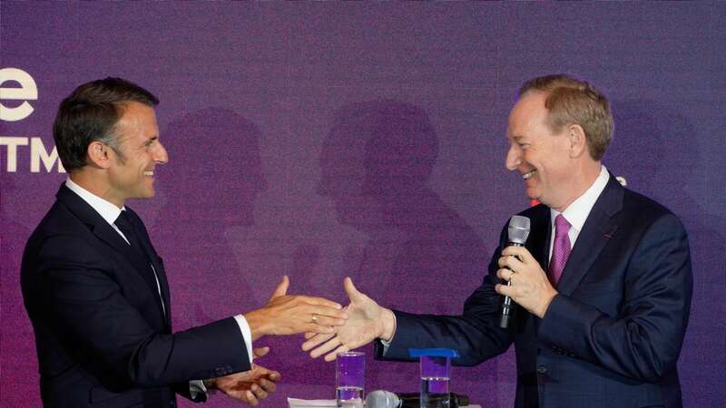 Microsoft CEO Brad Smith, right, shakes hands with French President Emmanuel Macron at the French Microsoft headquarters in Issy-les-Moulineaux, outside Paris (Image: Copyright 2024 The Associated Press. All rights reserved.)