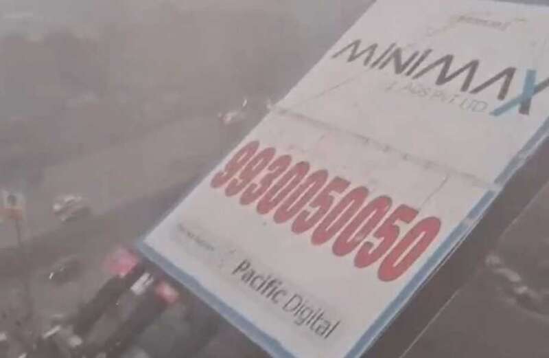 Harrowing footage shows the moment the billboard collapses crushing everything in its path as it falls