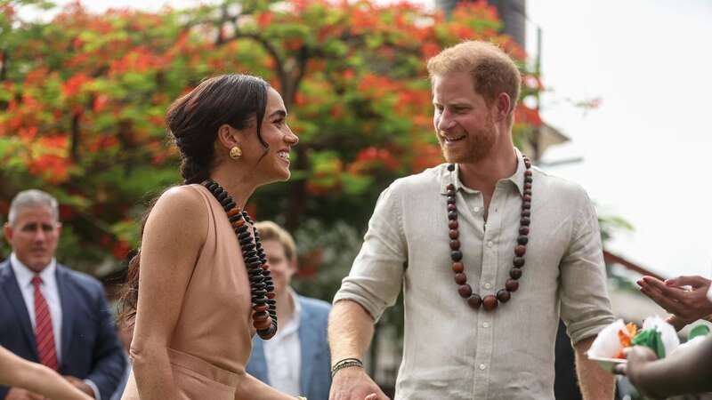 Prince Harry and Meghan, Duchess of Sussex, arrive at the Lightway Academy in Abuja as they visit Nigeria as part of celebrations of the Invictus Games anniversary (Image: AFP via Getty Images)