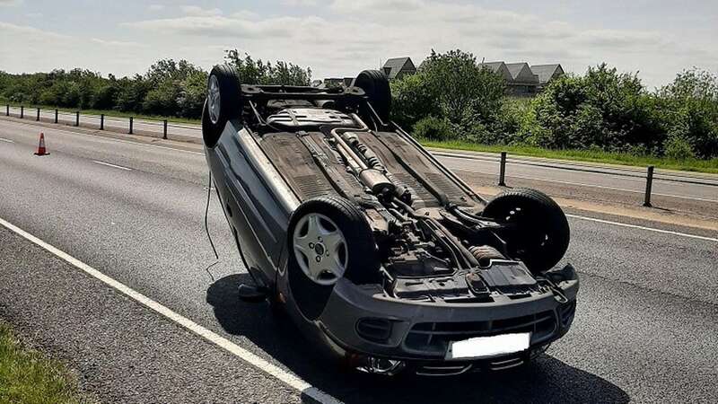 The overturned car on the A428 in Cambridgeshire (Image: Policing South Cambridgeshire/SWNS)