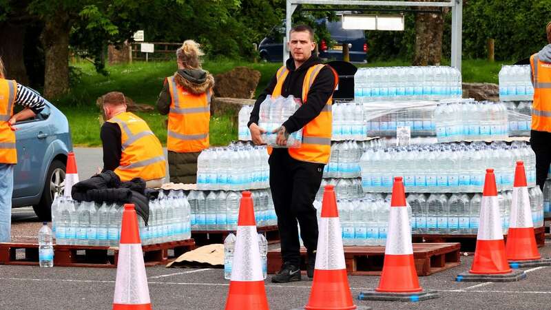 Water supplies being given out in Brixham as residents are hit by a parasite in local water supplies (Image: Alamy Live News.)