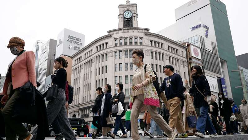 People walk across a pedestrian crossing in Ginza shopping district in Tokyo. The Japanese economy shrank at an annual rate of 2% in the first quarter of this year (Image: Copyright 2023 The Associated Press. All rights reserved)