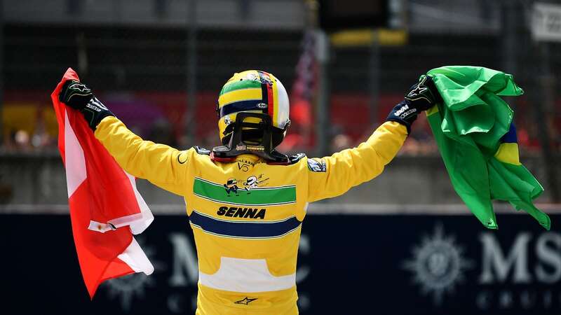 Sebastian Vettel holds the Austrian and Brazilian flags in tribute to Roland Ratzenberger and Ayrton Senna (Image: Formula 1 via Getty Images)