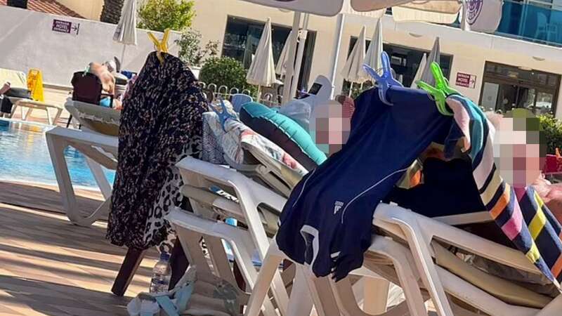 Two men were seen relaxing on multiple sunbeds stacked on top of each other (Image: Daily Mail)