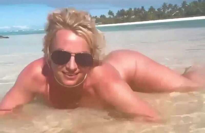 The singer released a video of herself writhing around in the buff on the beach