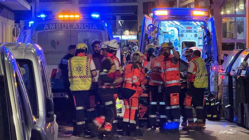 Emergency responders carry bodies away from the scene of the collapse in Palma (Image: ASSOCIATED PRESS)