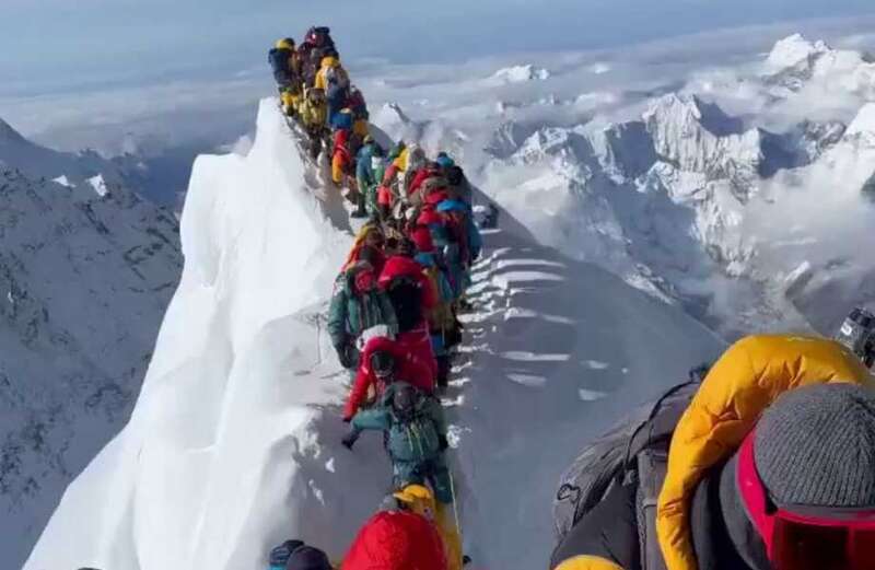 Watch the staggering video showing the hundreds of mountaineers in summit suits, roped in but going nowhere