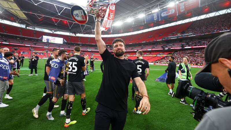 Russell Martin holds the trophy aloft (Image: Kieran McManus/REX/Shutterstock)