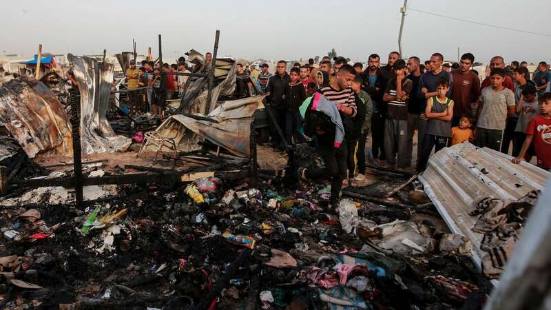 Palestinians look at the destruction after an Israeli strike where displaced people were staying in Rafah (Image: Copyright 2024 The Associated Press. All rights reserved.)