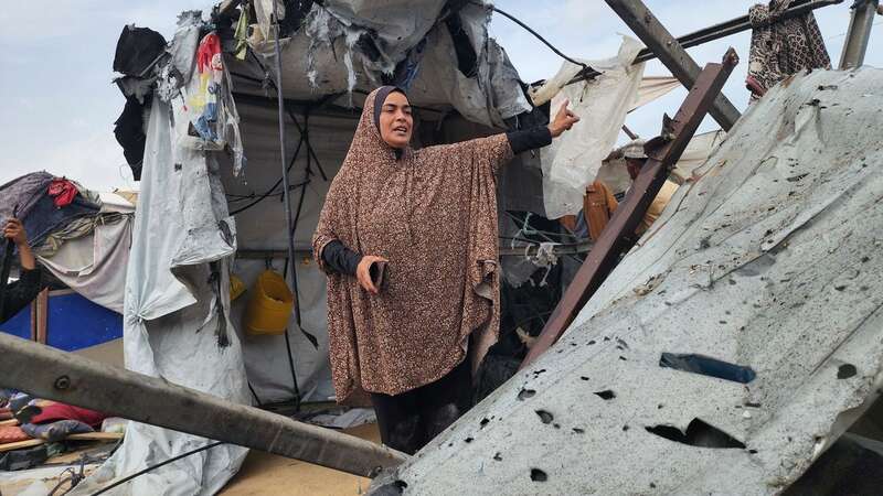 Palestinians examine the destroyed makeshift tents and collect usable items after Israeli army attacks (Image: Anadolu via Getty Images)