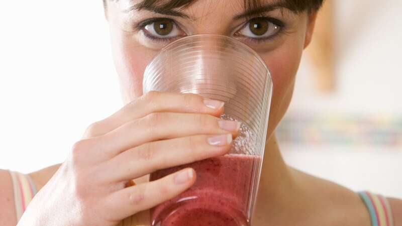 Smoothies might not be as good for weight loss as many think (Image: Woman drinking a fruit smoothie)