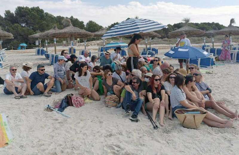 Watch as Majorcan families gather under umbrellas on a beach in protest of mass tourism