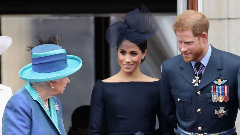 The late Queen with Prince Harry and Meghan Markle (Image: Getty Images)