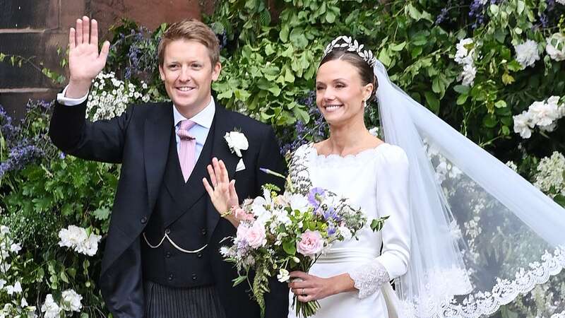 The happy couple beamed as they left the ceremony (Image: Alan Chapman/Dave Benett/Getty I)