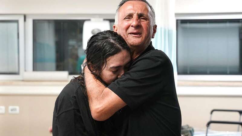 Israeli hostage Noa Argamani is embraced by her weeping father Yakob (Image: Israeli Army/AFP via Getty Image)