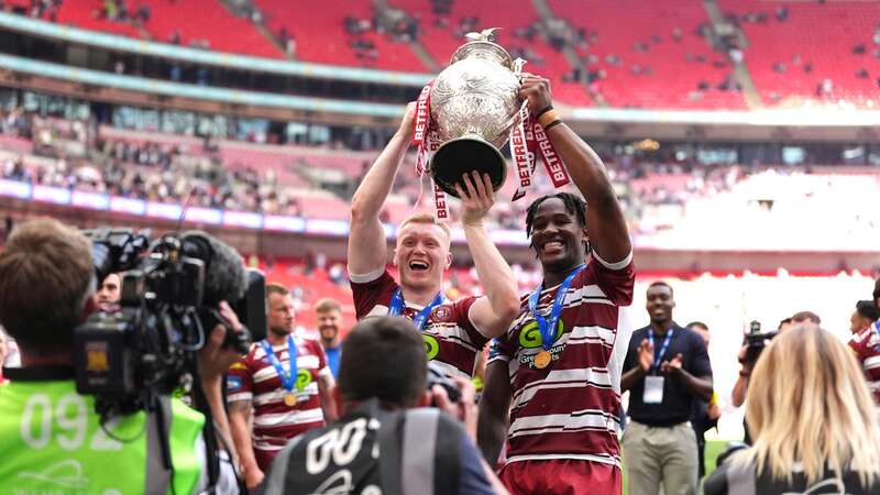 Eckersley (L) hoists the Challenge Cup with teammate Junior Nsemba (Image: PA)