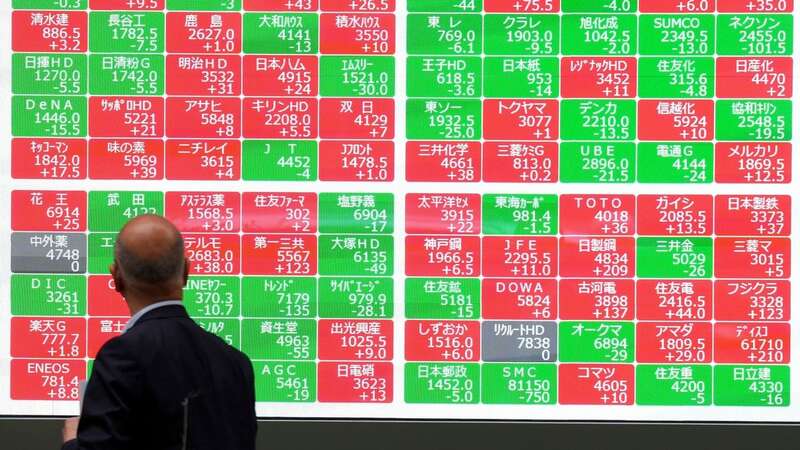 A person looks at an electronic stock board at a securities firm in Tokyo (Image: Copyright 2024 The Associated Press. All rights reserved)