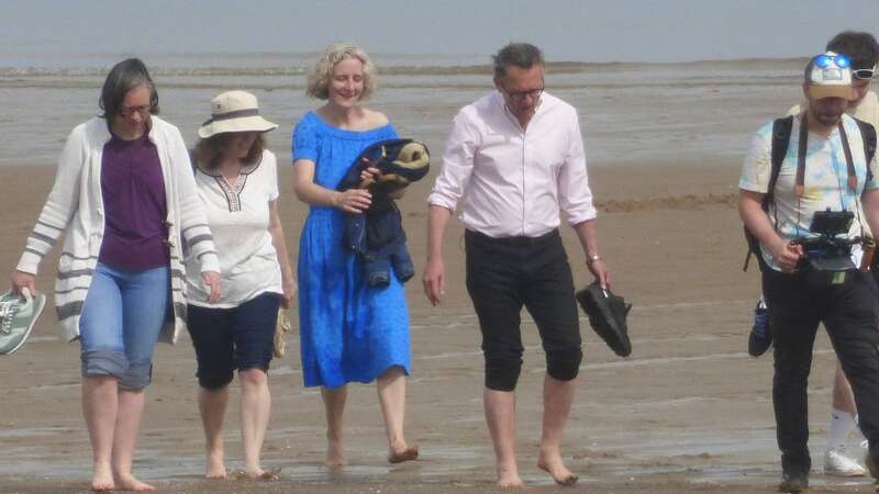 Michael Mosley seen alongside wife Clare and others, including a camera crew, at Colwyn Bay, north Wales, on May 10 (Image: / SWNS)