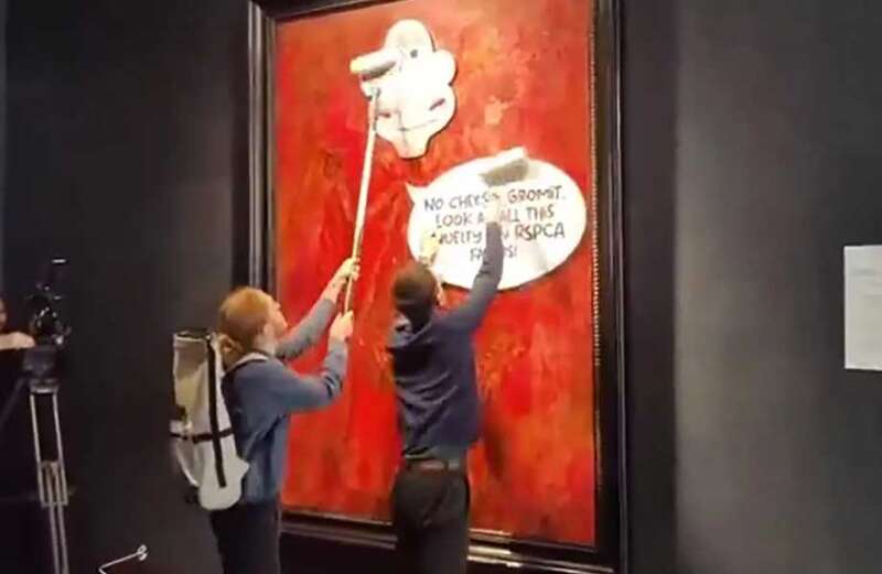 Watch the video above to see the shocking moment two zealots defaced the portrait