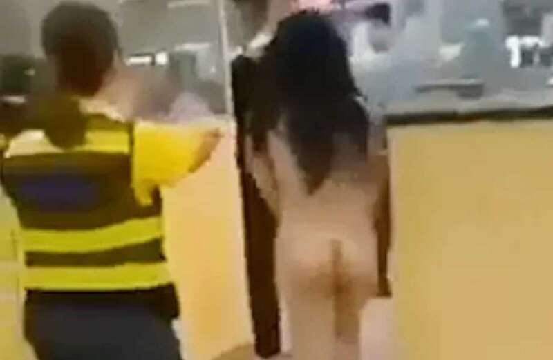 Footage captures baffled staff chasing after the woman as she storms through body scanners