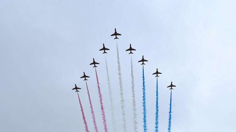 Crowds watch the Royal Air Force Red Arrows perform a flypast over The Mall towards Buckingham Palace in 2023 (Image: Getty Images)