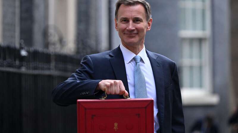 Box fresh: The Chancellor holds his briefcase aloft on Budget day in March (Image: AFP via Getty Images)