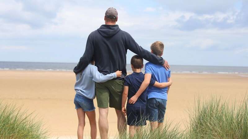 The three kids in a picture with their dad taken in Norfolk last month