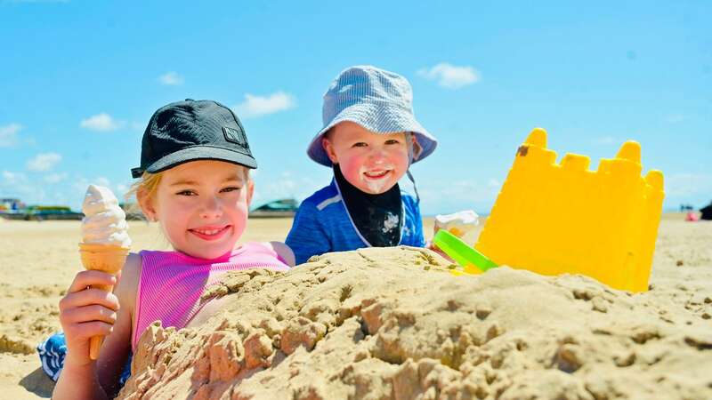 Little Isla May and Frankie play in the sand at Lytham St Annes, Lancashire on Sunday (Image: Dave Nelson)