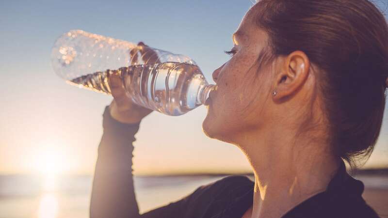 An expert advises us not to drink bottled water that has been left in the sun or a hot environment, like a car. (Image: Getty Images)