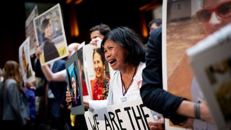 Clariss Moore of Toronto, Canada, holds a photograph of her daughter Danielle Moore and stands with other family members of those killed in the Ethiopian Airlines Flight 302 and Lion Air Flight 610 (Image: Getty Images)