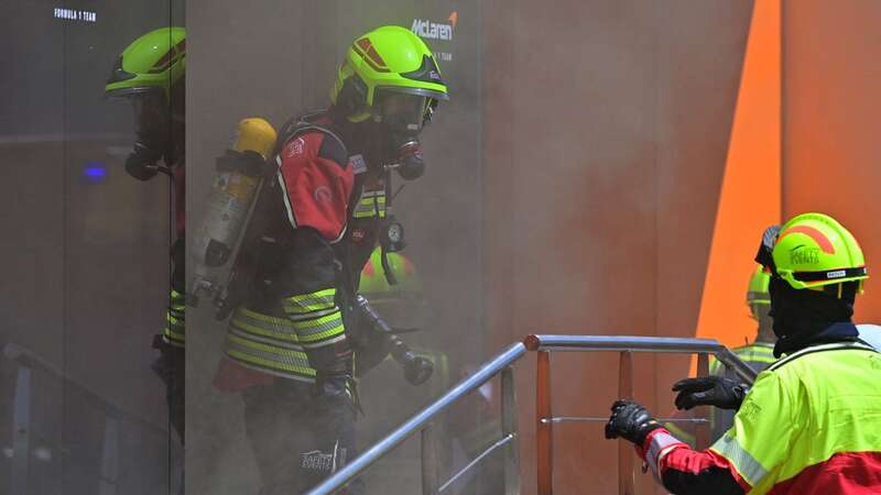 Firefighters work on the McLaren hospitality unit (Image: AFP via Getty Images)