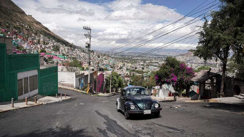 Janette Navarro drives her 1996 Volkswagen Beetle up a steep hill in the Cuautepec neighborhood of Mexico City (Image: Copyright 2024 The Associated Press. All rights reserved)