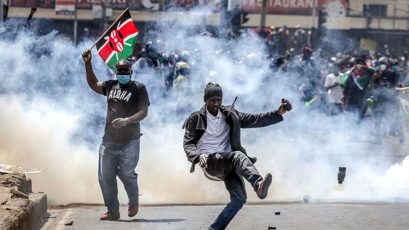 A protester in Nairobi kicks a tear gas canister away after it was fired at crowds by riot police (Image: AFP via Getty Images)