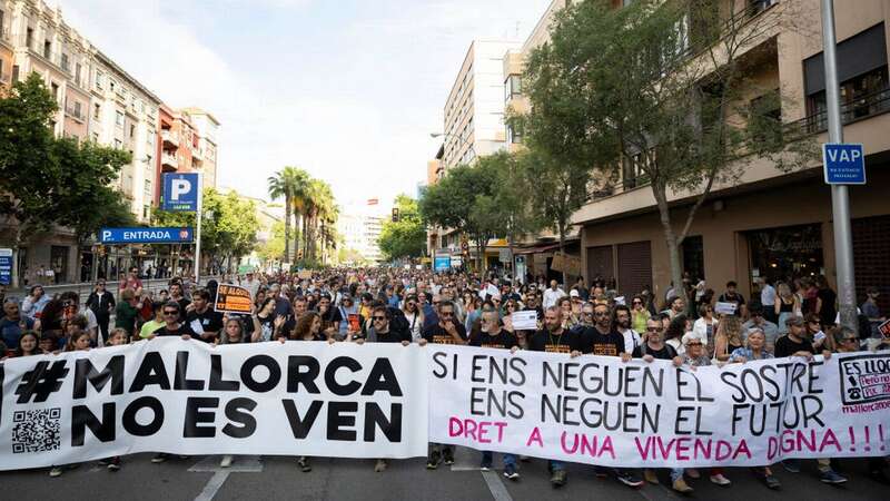 Protesters hold a banner reading "Mallorca is not for sale" during a demonstration to protest against the massification of tourism and housing prices on the island of Mallorca in Palma de Mallorca (also known as Majorca) (Image: JAIME REINA/AFP via Getty Images)