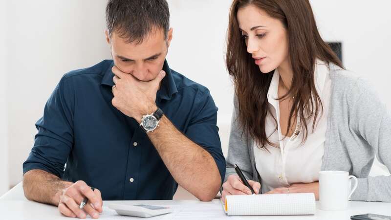 A couple looking at their bills (Image: Ridofranz)