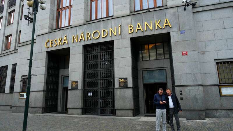 People stand outside the Czech central bank in Prague, Czech Republic (Image: Copyright 2023 The Associated Press. All rights reserved)