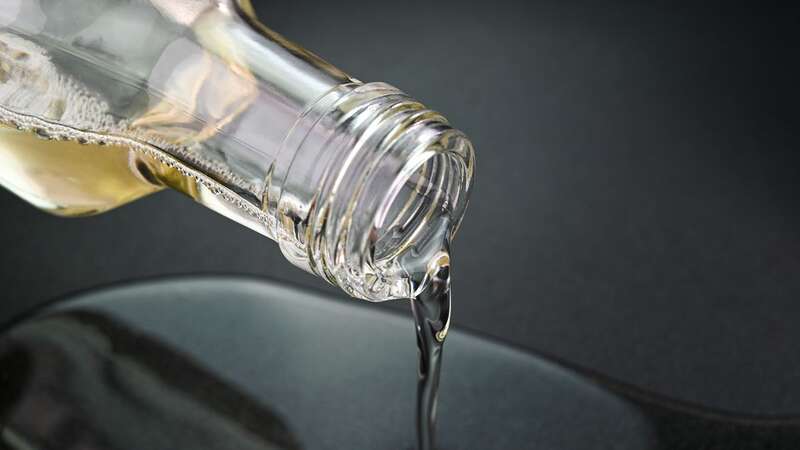 Pouring coconut oil in a pan