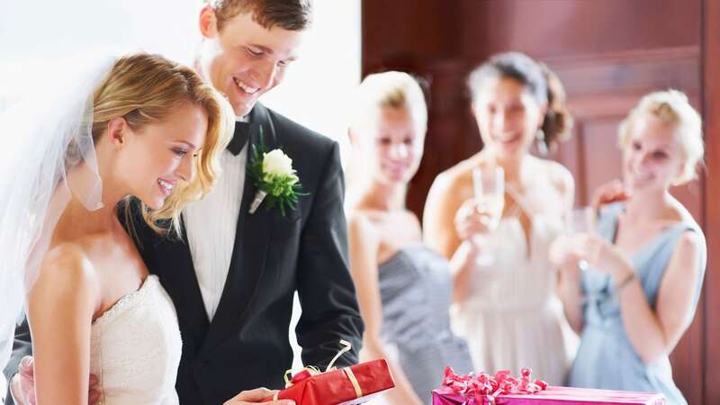 The bride and groom want their gifts ahead of their wedding (stock photo) (Image: Getty Images/Tetra images RF)