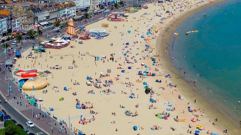 Sunbathers enjoying sunshine in Weymouth, Dorset (Image: Graham Hunt/BNPS)