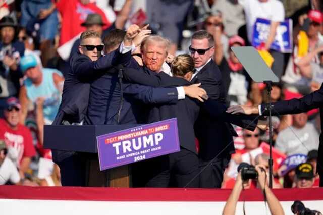 Donald Trump falls to ground bleeding after gun attack at rally