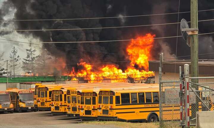 A wildfire burns near a school bus depot on the edge of Williams Lake, in the Cariboo region of British Columbia, Canada, Sunday 21 July 2024. Photograph: Spencer Stratton/Reuters