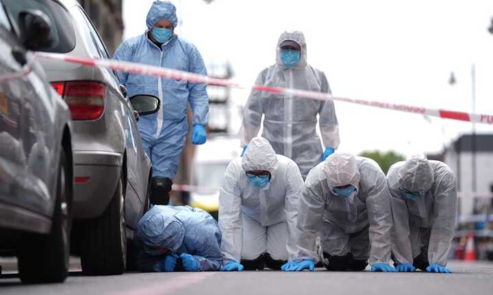 Police forensic officers in Dalston, east London, near to the scene of the 29 May shooting. Photograph: James Manning/PA