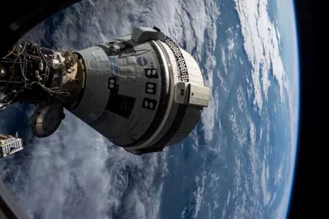 Boeing’s Starliner spacecraft seen docked to the Harmony module of the International Space Station on July 3, 2024, seen from a window on the SpaceX Dragon Endeavour spacecraft docked to an adjacent port (Picture: AP)