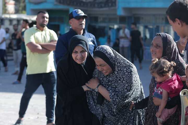 Palestinians mourn as the civil defence teams and civilians carry out search and rescue operations from the rubble after an Israeli attack on Nuseirat Refugee Camp. Photograph: Anadolu/Getty Images