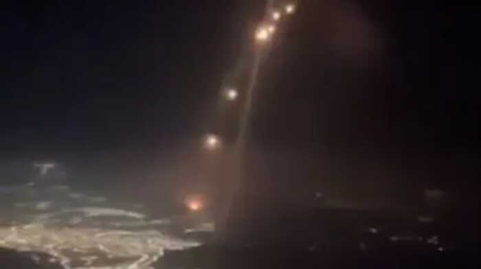 Footage shows a flight narrowly avoiding the Iranian missiles as they rained down over Israel on Tuesday evening