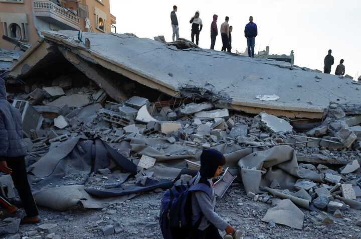 Palestinians examine the site of an Israeli strike on a house in Khan Younis. Photograph: Mohammed Salem/Reuters