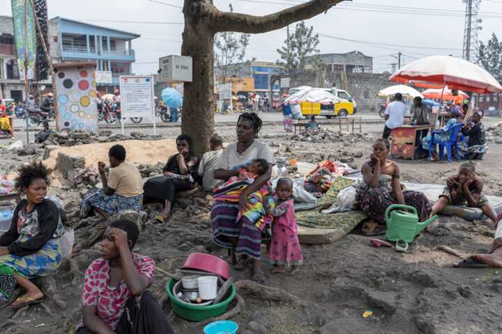 Congolese civilians displaced in fighting between M23 rebels and the DRC army take refuge near a church in Goma. Thousands of bodies await burial in the city. Photograph: Arlette Bashizi/Reuters